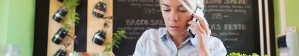 Woman working at a small cafe business.