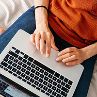 Close up of hands working on computer.