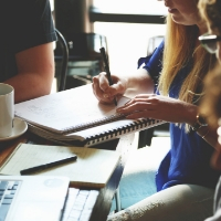 Group of people working on a business project at a table.