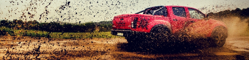 Truck driving through mud.