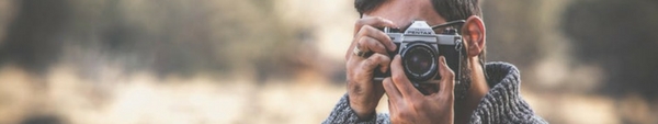 Man taking a picture with a camera.