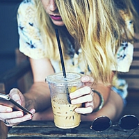 Girl with phone and coffee.