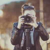 Woman taking photos with camera.