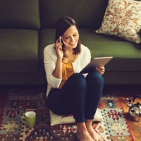 Woman talking on her phone in her living room.