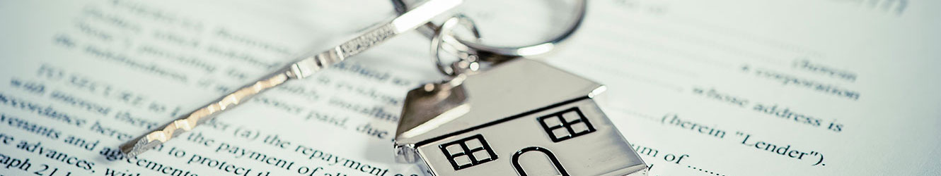 Conceptual mortgage photo, key sitting on paperwork.