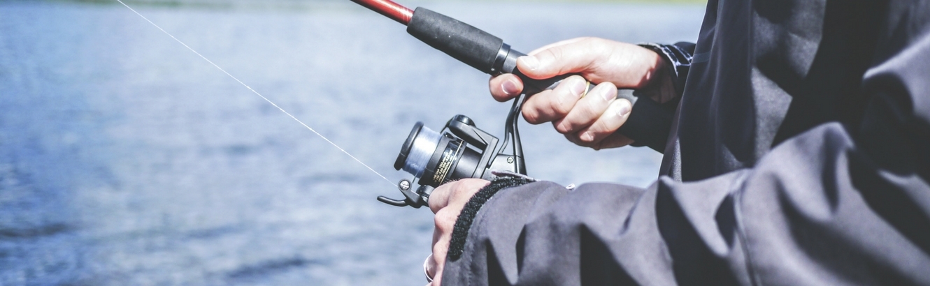 Man fishing with his fishing pole.