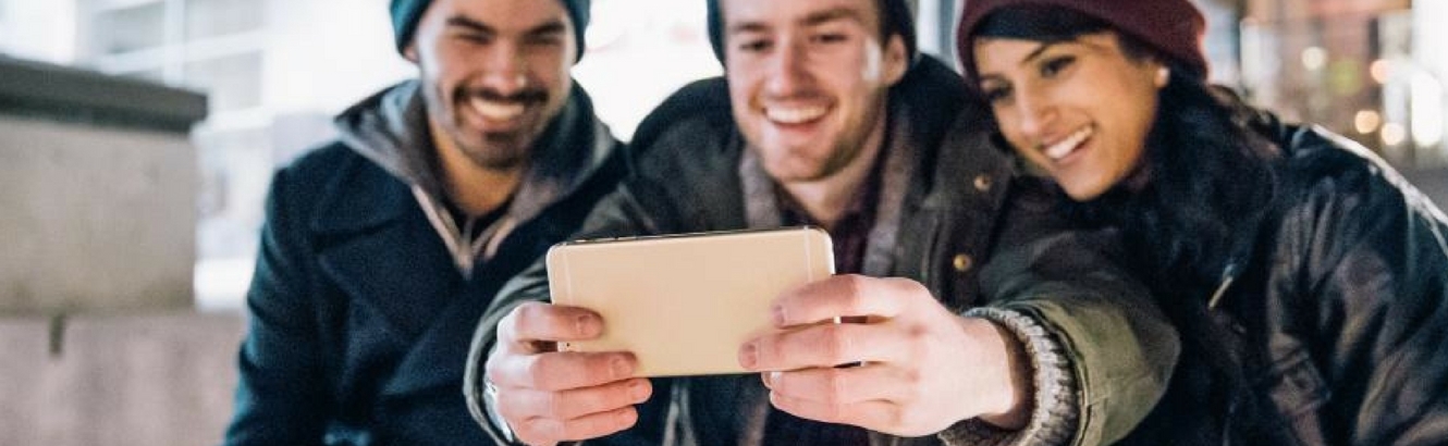 Group of people taking a selfie.