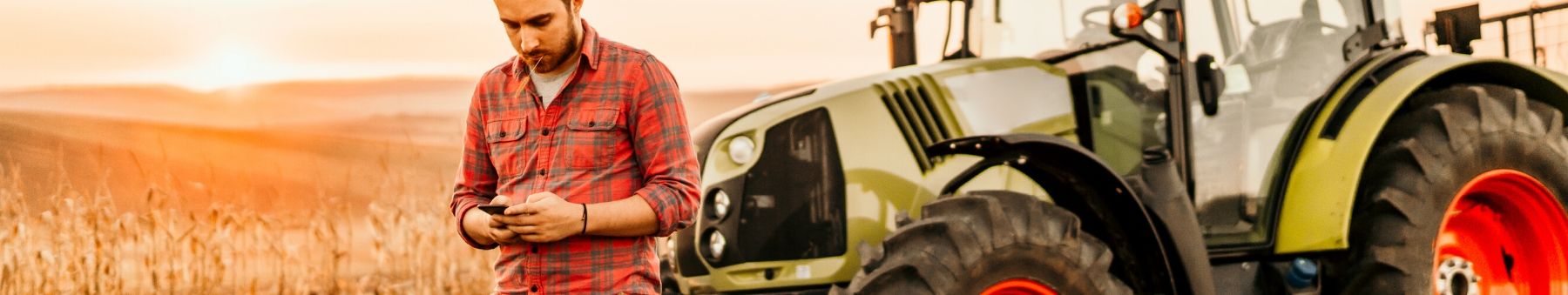 Farmer using his cell phone in a wheat field