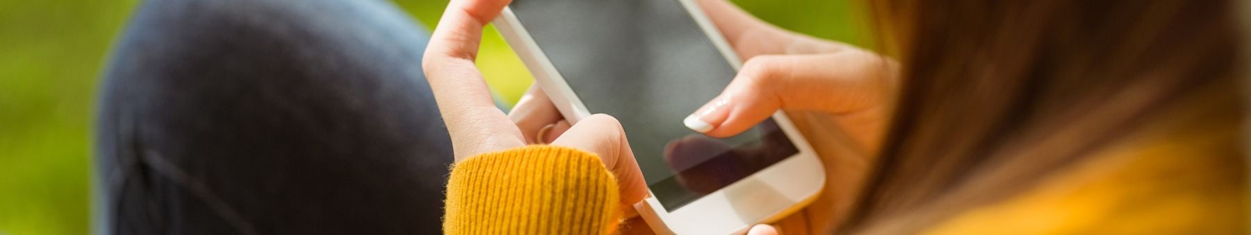 Close up of woman texting on her cell phone