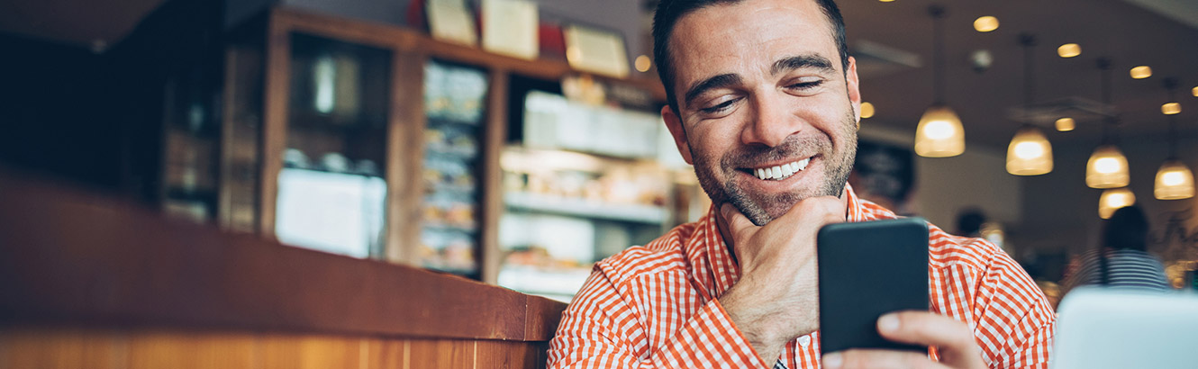 Man using phone in coffee shop