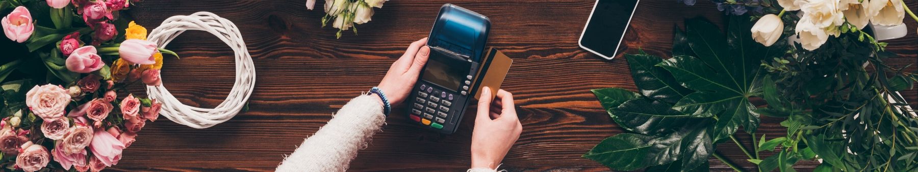 Debit card being used to pay for flowers at a flower shop