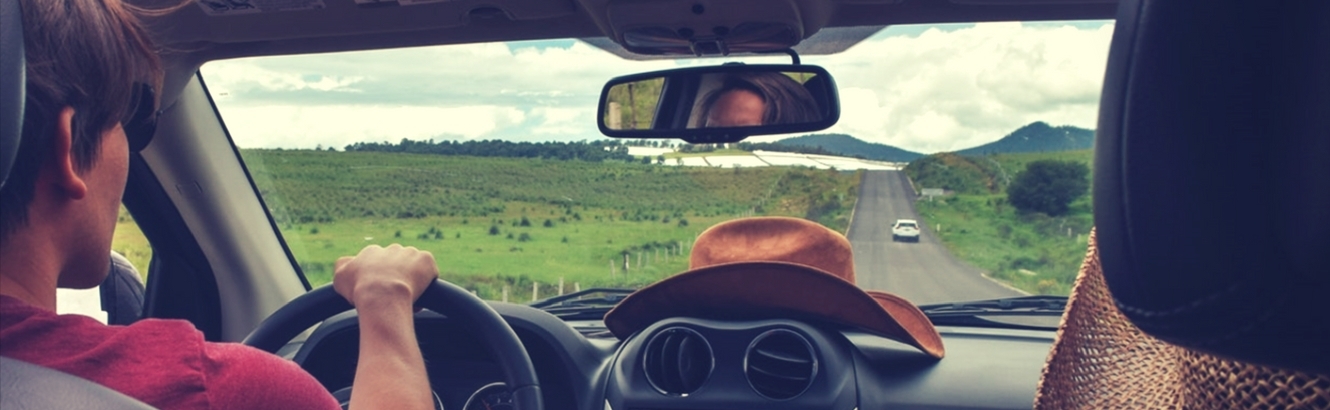 Interior view of people driving in a car.