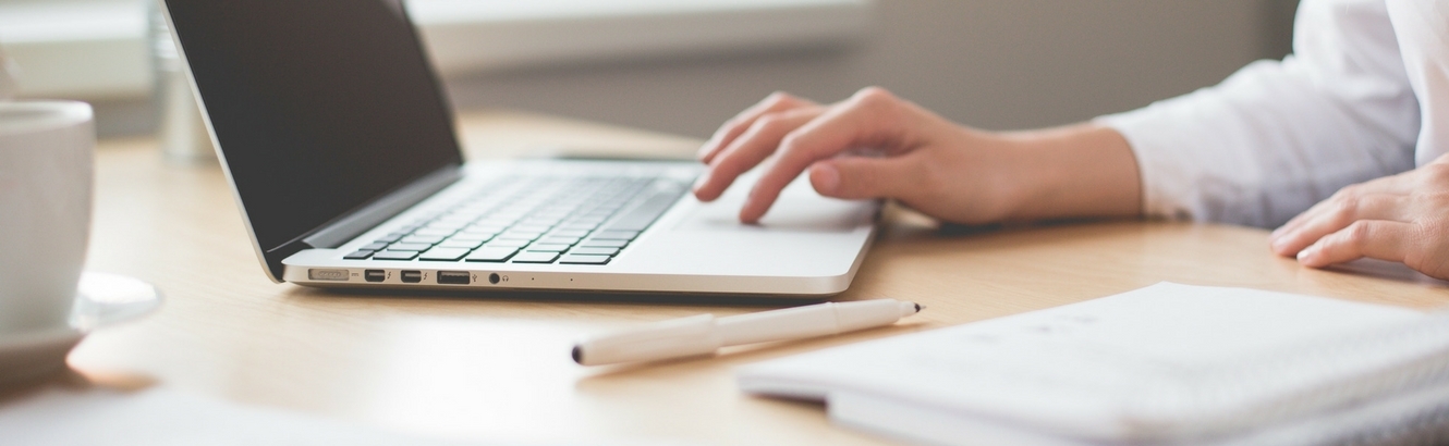 Person typing on a computer.