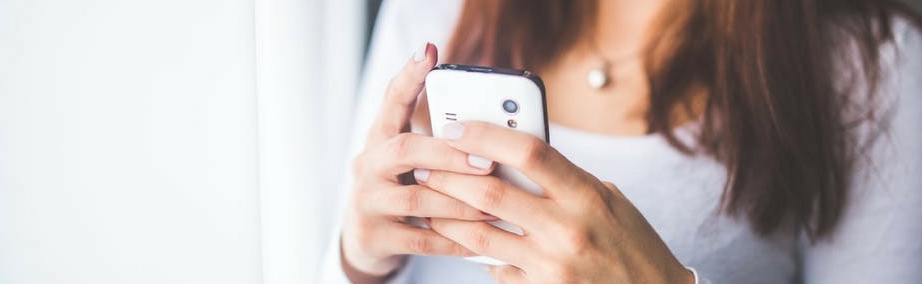 Woman texting on a phone.